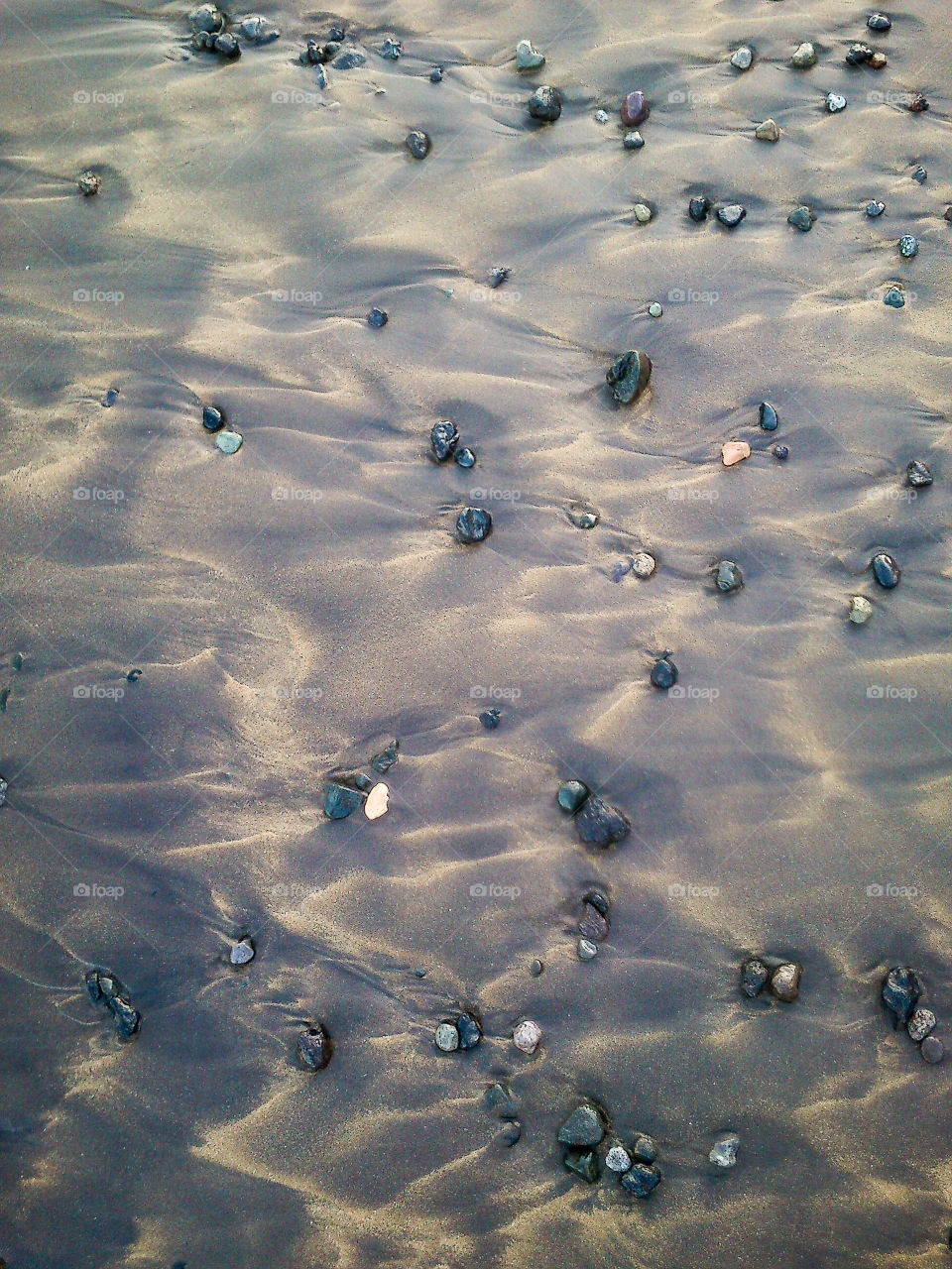 Pebbles on sand at beach