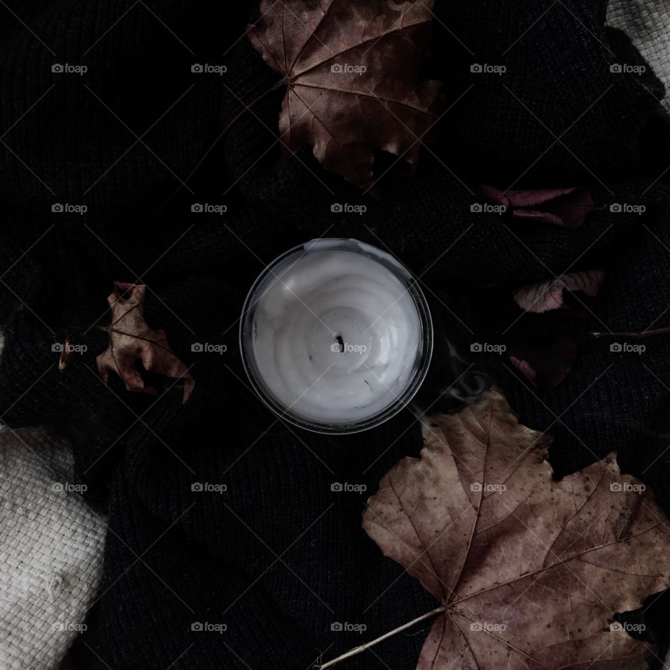 maple leaves and scented candle