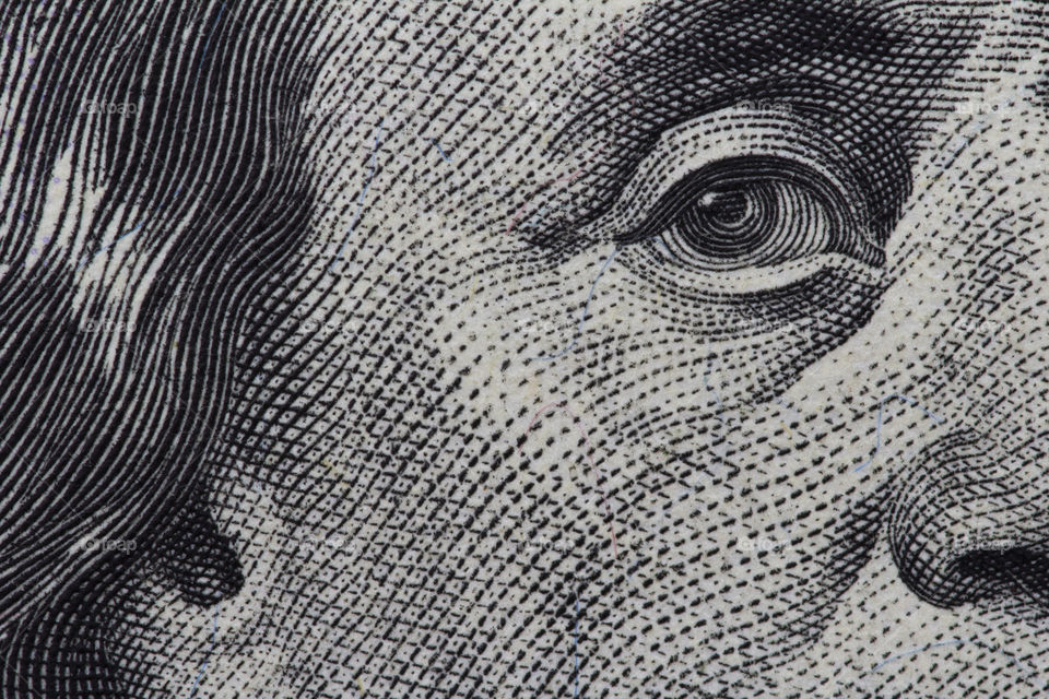 Benjamin Franklin's look on a hundred dollar bill.  portrait of the Benjamin Franklin , macro usa dollar banknote or bill