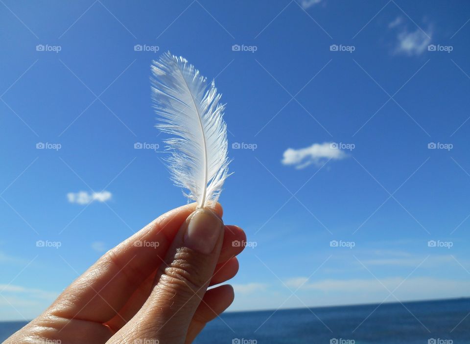 white weather in the hand blue sky and sea summer time