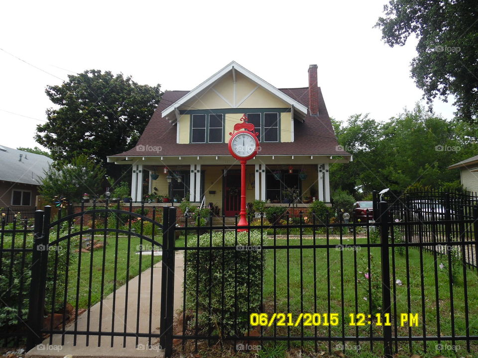 red vintage clock. This is a picture of a unique red clock that was sitting in the front of this house that I drove by in Weatherford Texas
