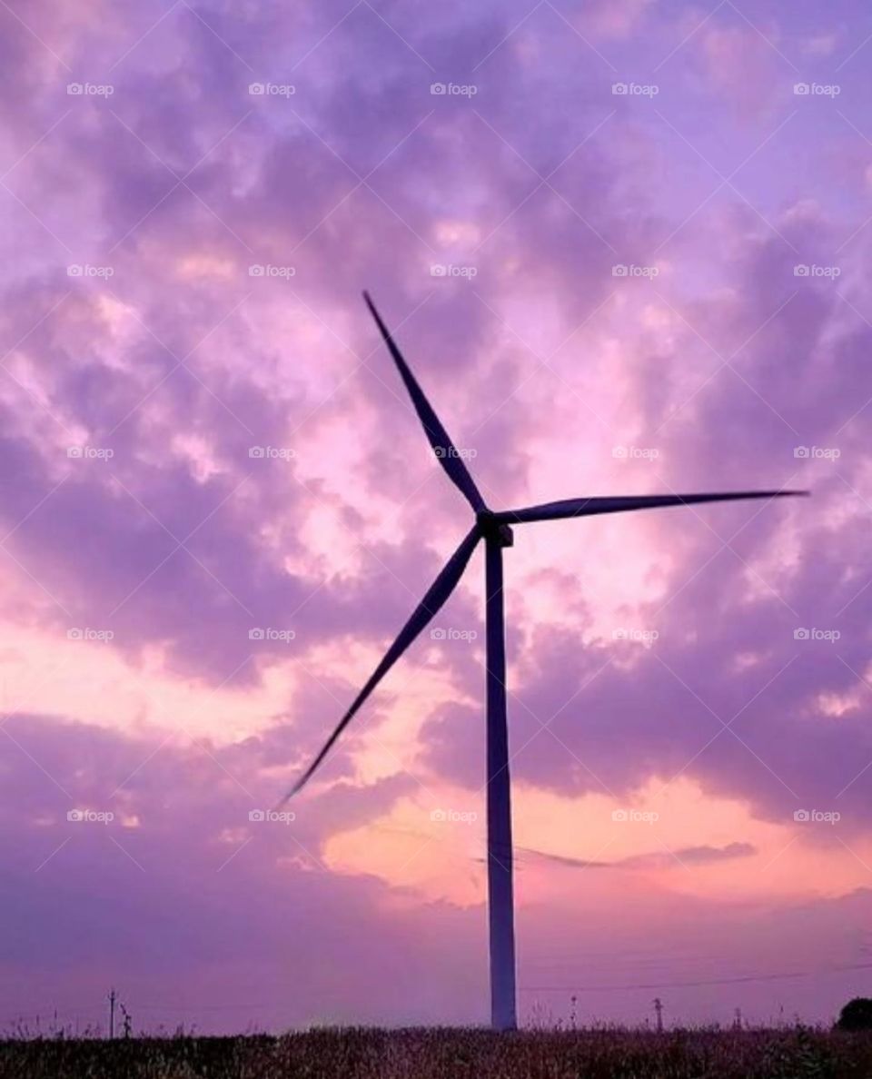 A windmill with a purple cloud's view