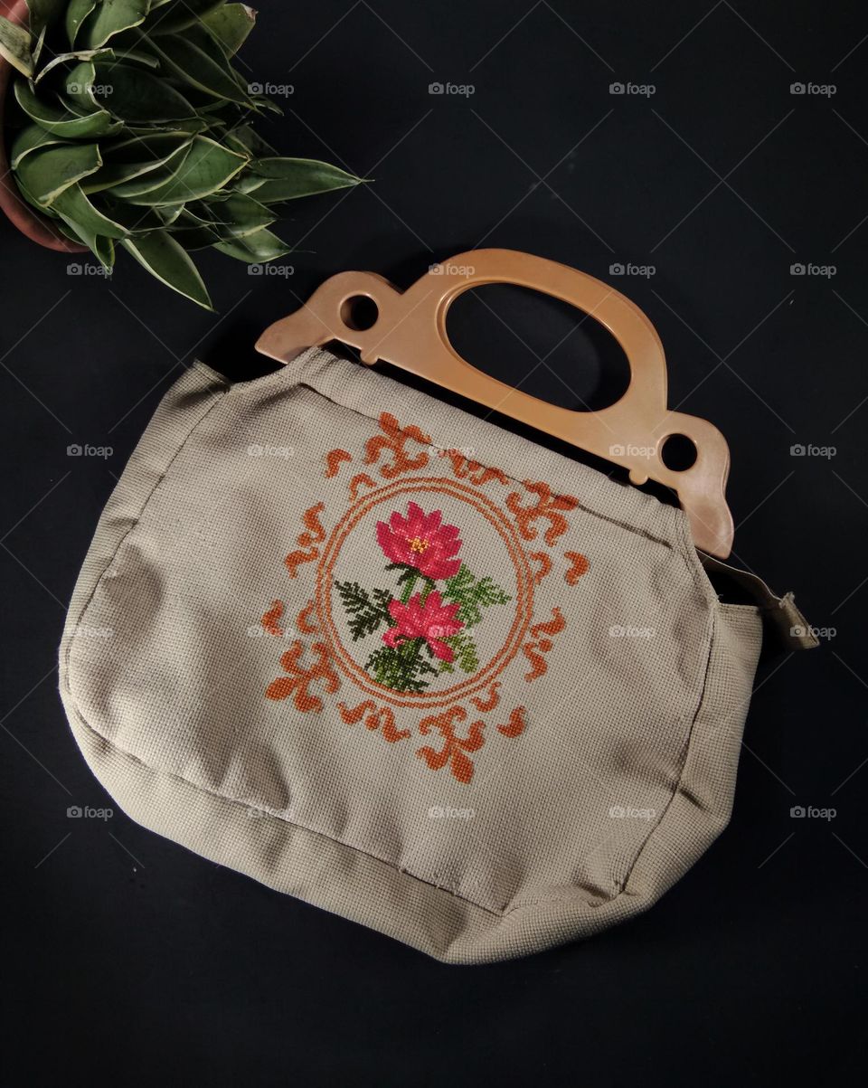 ladies bag. jute material with floral pattern and gold fleur de lys design