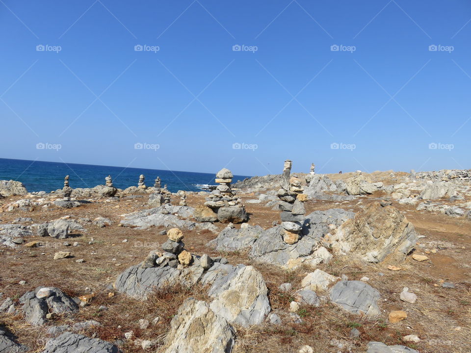 Seaside with lots of hand-made stone pyramids