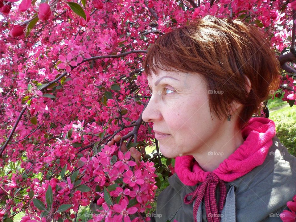 girl on the background of a flowering tree in spring