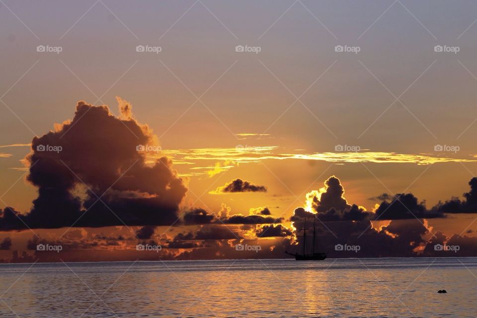 Nautical vessel in sea during sunset