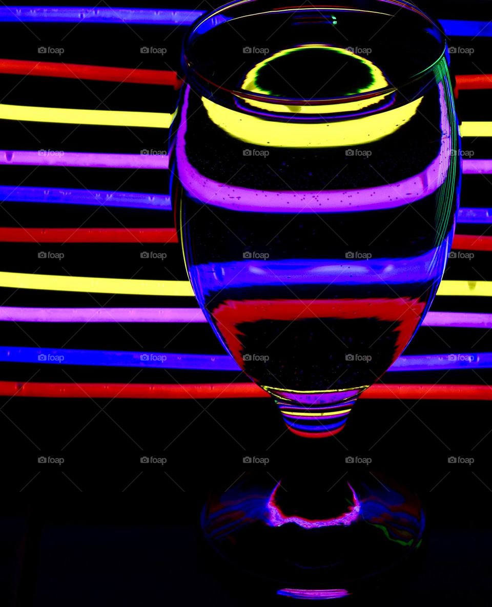 Neon lights reflected in a glass