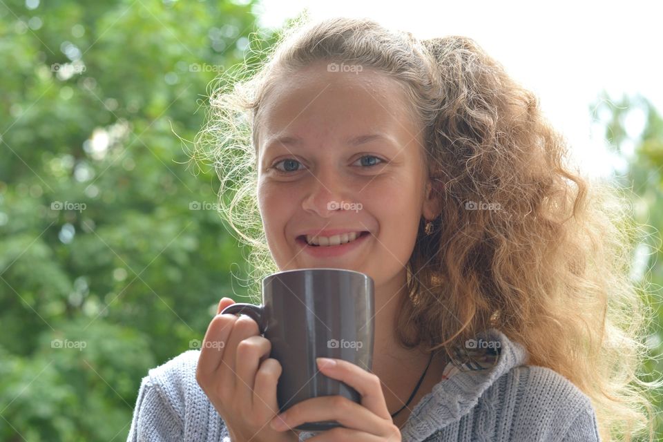 smiling teenage girl with cup beautiful portrait green background