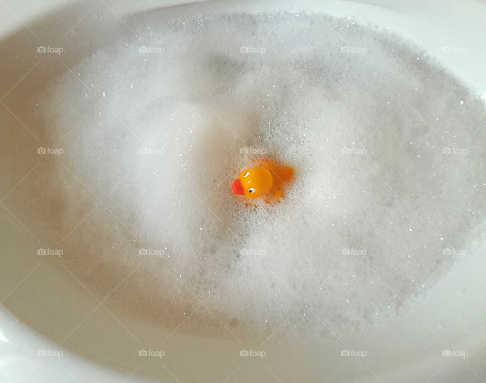 Rubber duck taking a foam bath