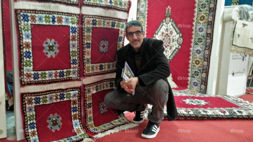 I m sitting besides moroccan carpets.