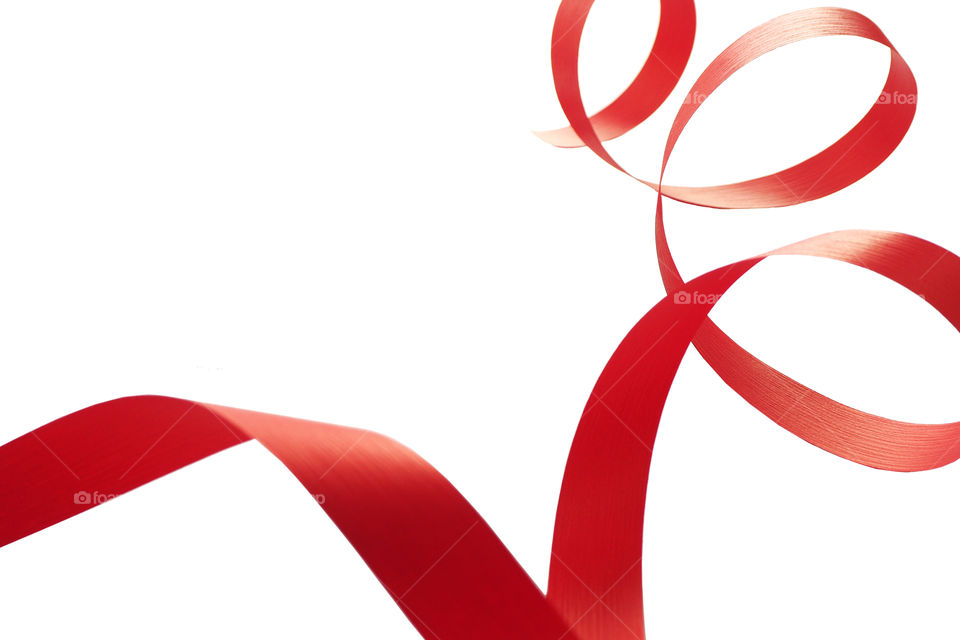 a red ribbon twisted into a spiral on a white background