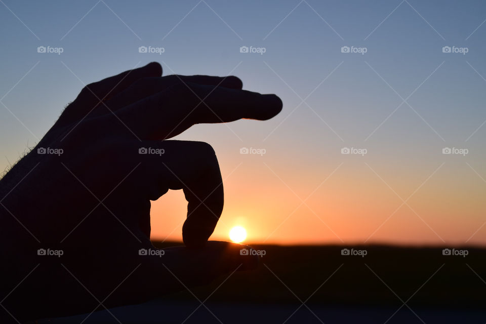 Man's hand during dusk