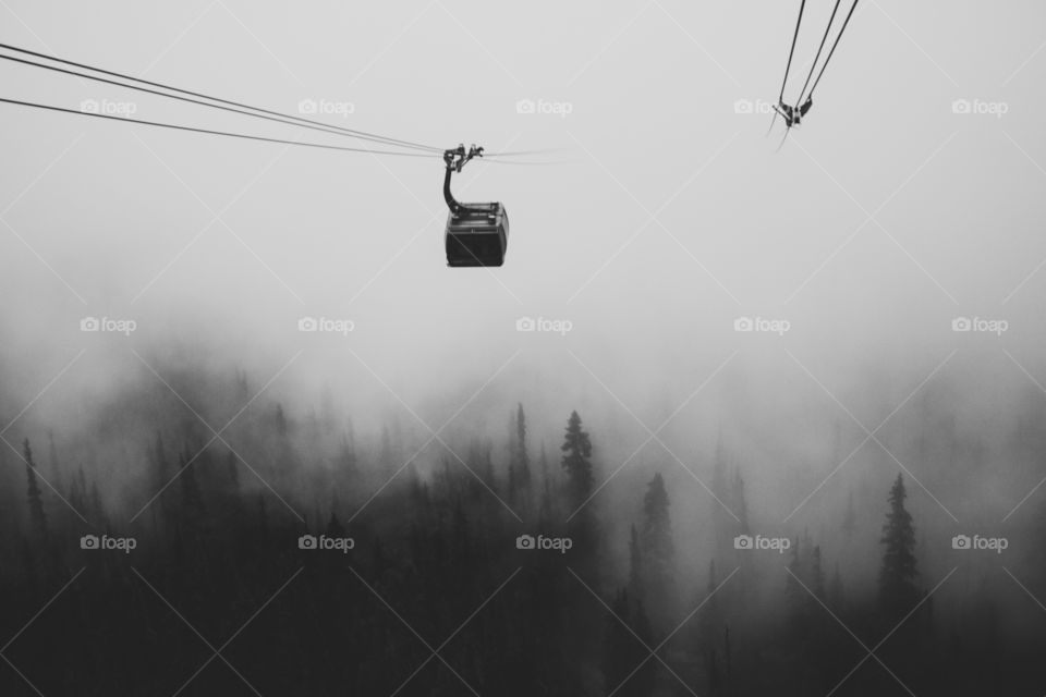 gondola over the forests and fog of Whistler, BC
