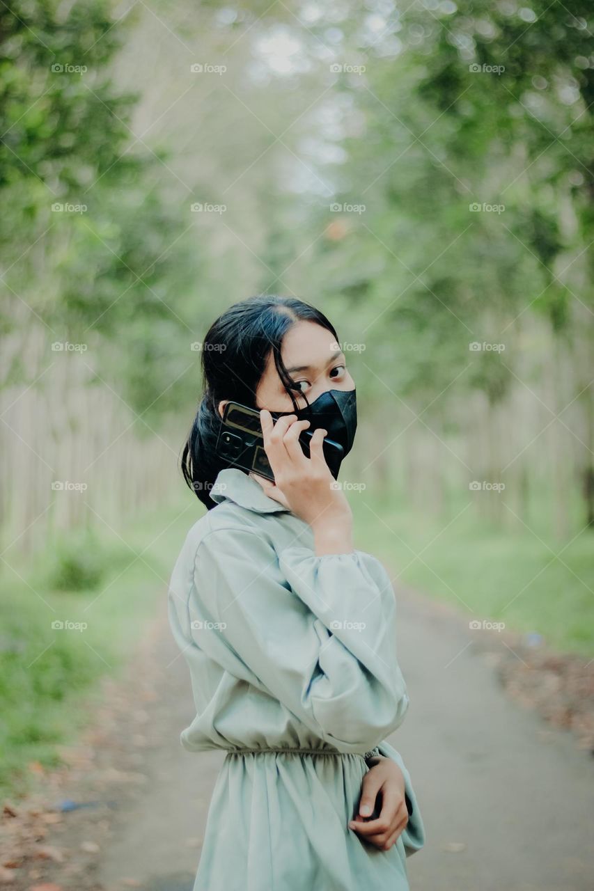 girl making a phone call in nature