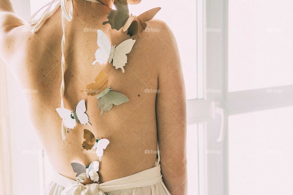 Rear view of backless women with butterfly shapes