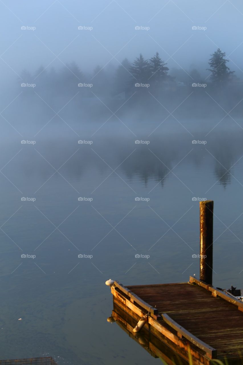 Dock on foggy morning, Devils Lake, Oregon. 