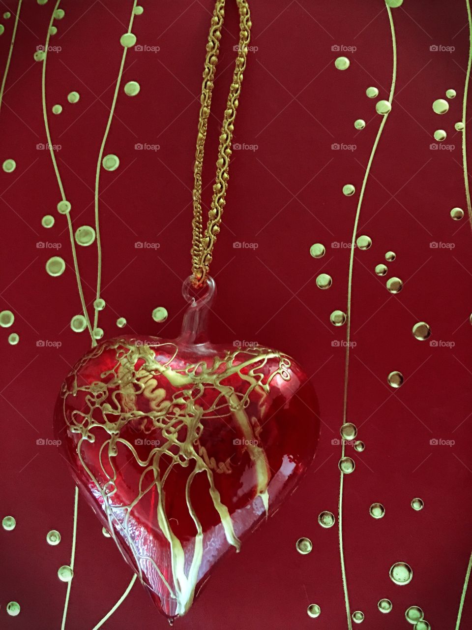 Bright red heart on gold cord 