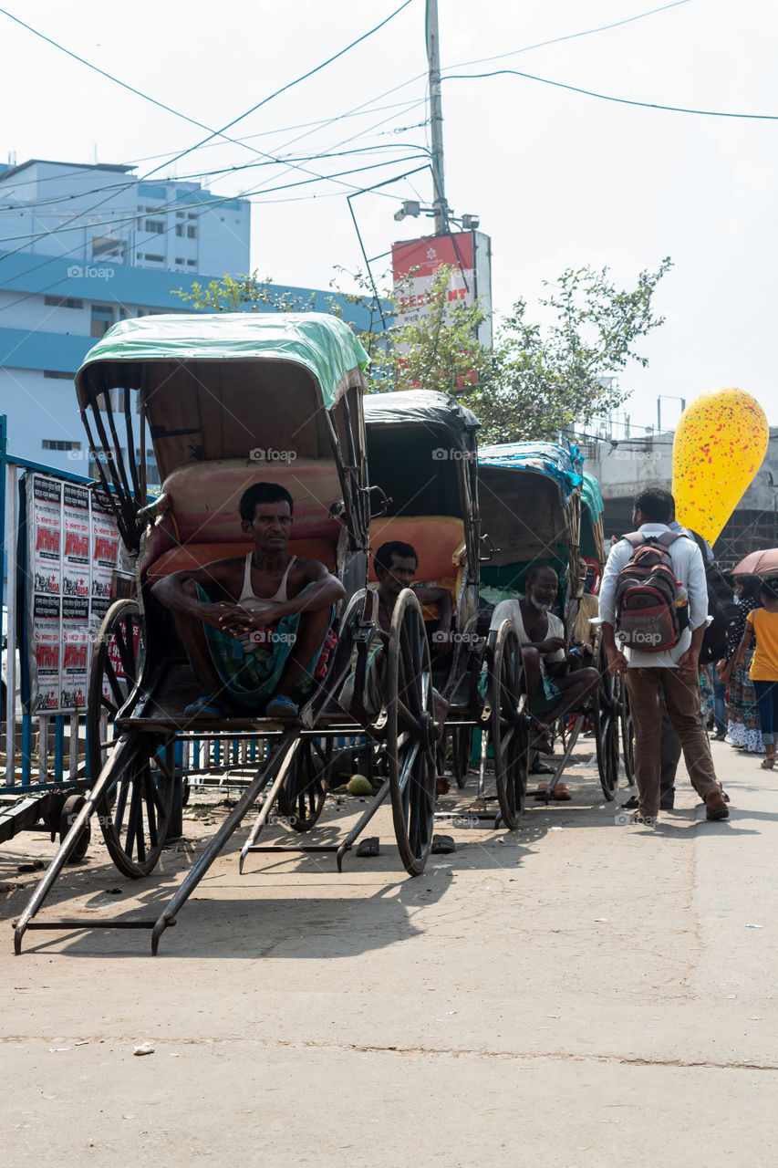 A pulled rickshaw is a mode of human-powered transport by which a runner draws a two-wheeled cart which seats one or two people. It can only be seen in various part of Kolkata specially College Street Road to Sealdah. It's the soul of Kolkata.
