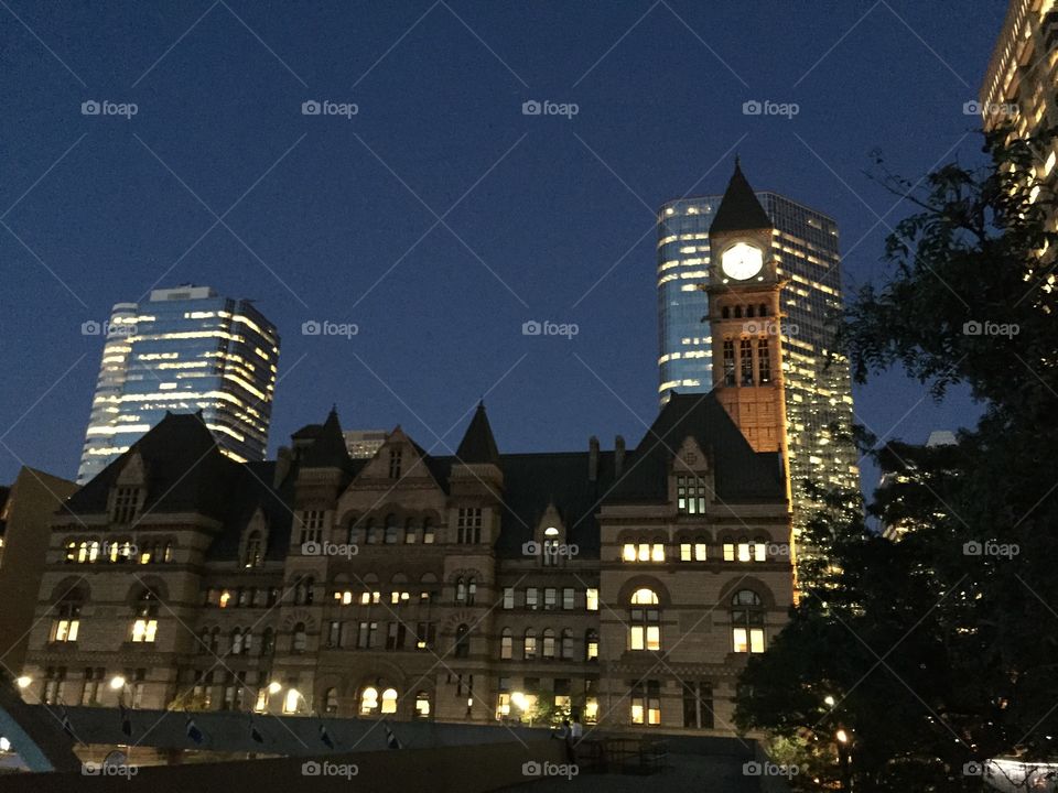 Old city hall in Toronto, early evening, windows illuminated.
