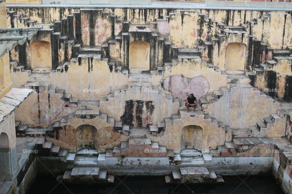 Man sitting on old structure