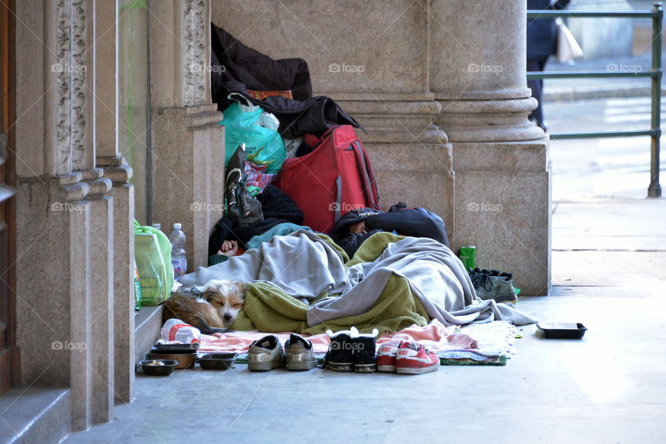 homeless people sleeping on the sidewalk