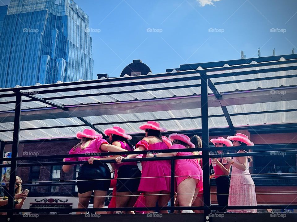 Girls weekend party in Nashville, United States. Women riding a party bus enjoy the revelry on lower Broadway!