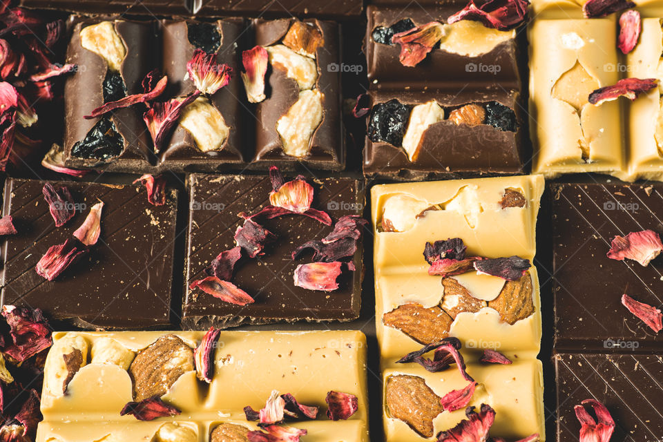 Different kinds of chocolate with rose petals
