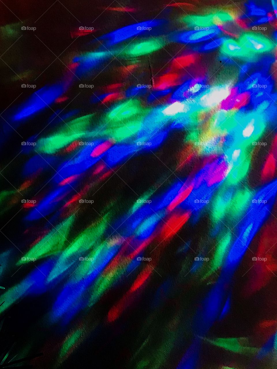 The coloured beam from a kaleidoscope Christmas strobe light. I love the colours and it lights up the room with sparkling colours day & night! Also makes great wallpaper on my phone!