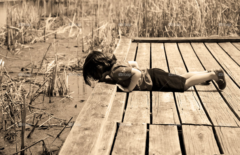 Getting a closer look. Little boy gazing into marsh at Rollins Savanna Forest Preserve,  Gray's lake,  Illinois