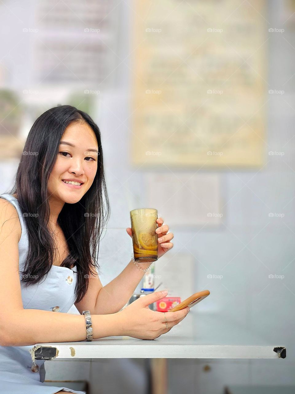 Lady happy to get her lemon ices tea from a traditional tea restaurant