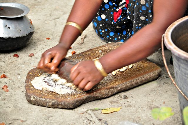 A lady`s making garlic paste for cooking