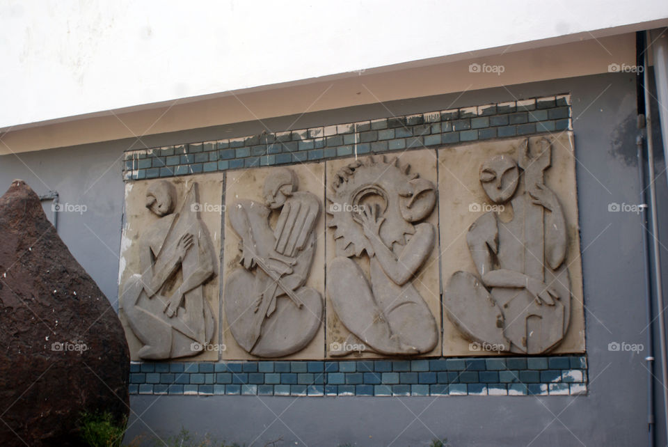 Murals on the wall depicting music in simplified form.