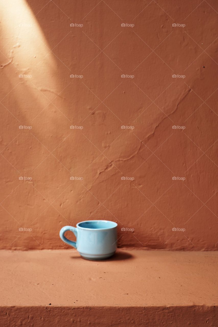 blue cup and orange wall
