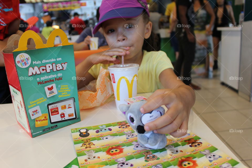 little happy girl eating at McDonald's