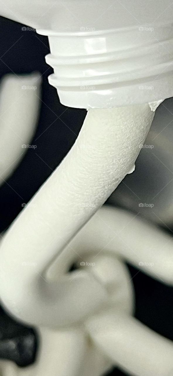 Squeezing cream out of a tube. Close-up.
