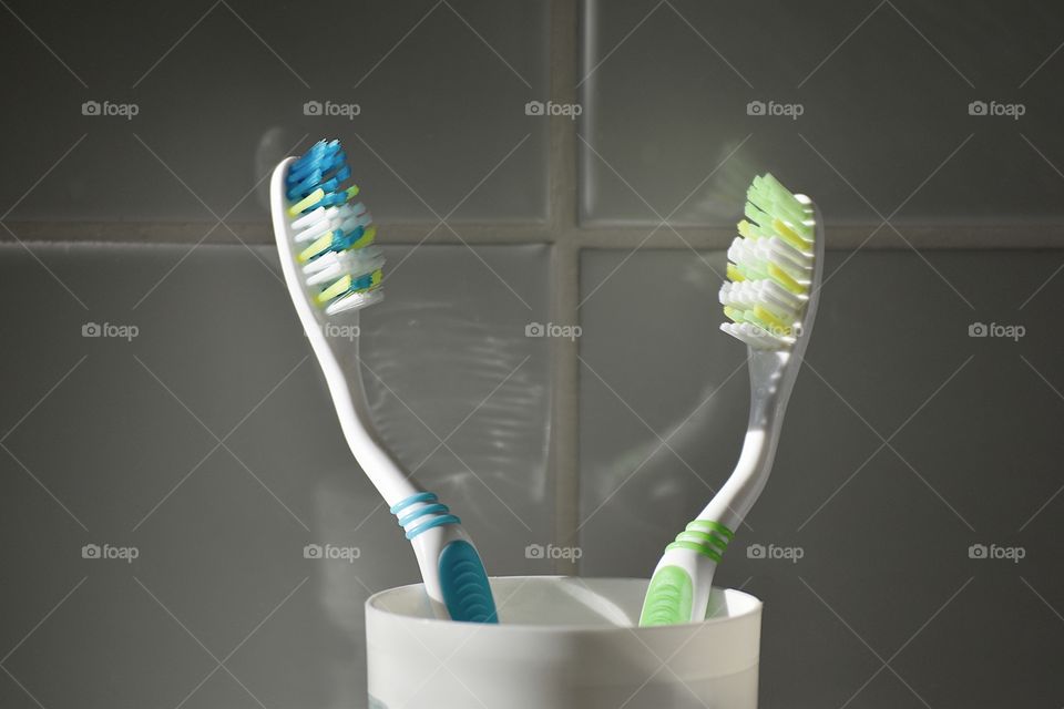 2 toothbrush in a cup in close up