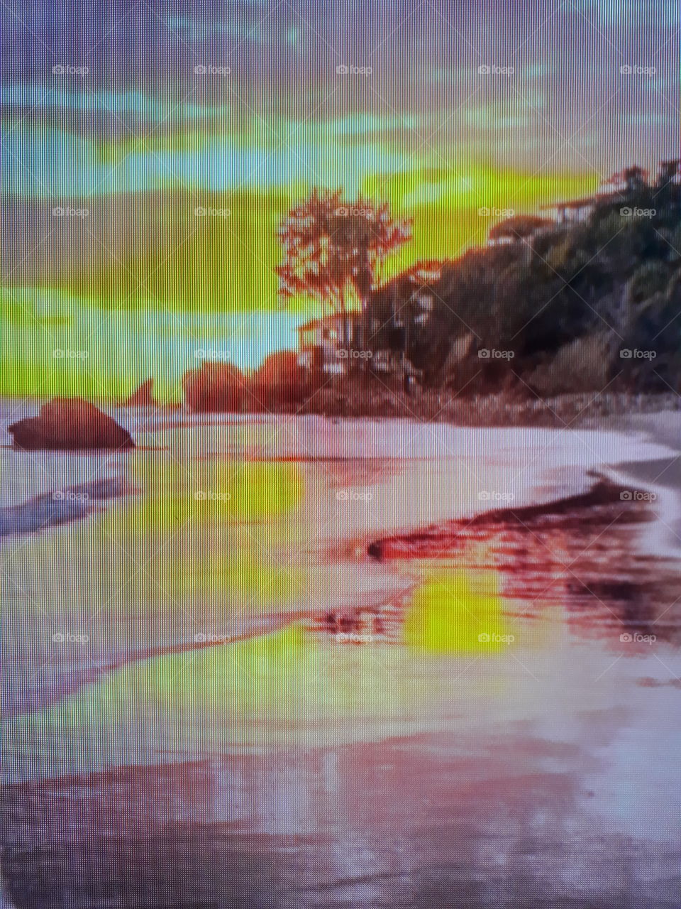 sunset on the beach with beautiful golden in the background and mirrored waters reflecting the golden sunset