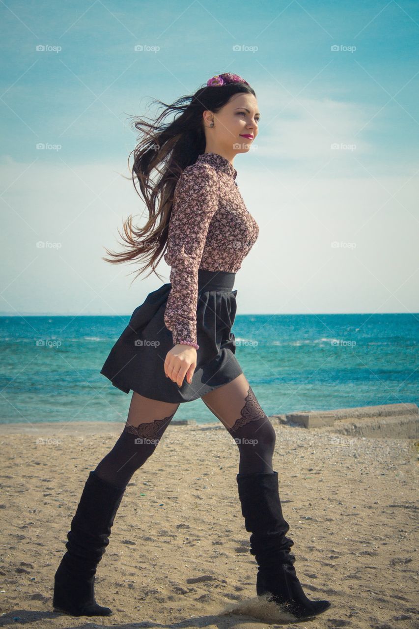 Young woman walking on beach