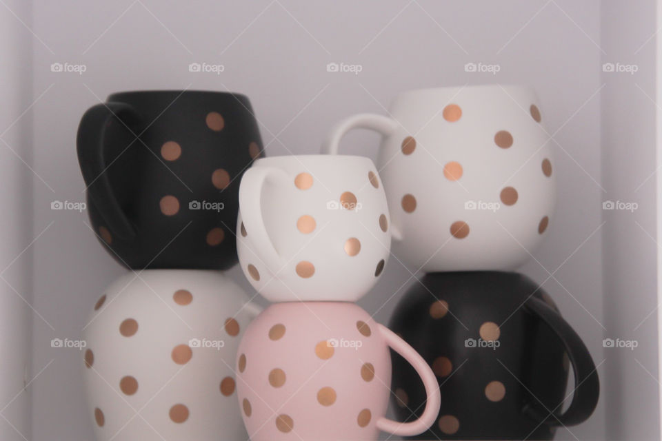 6 hug mugs stacked on a shelf