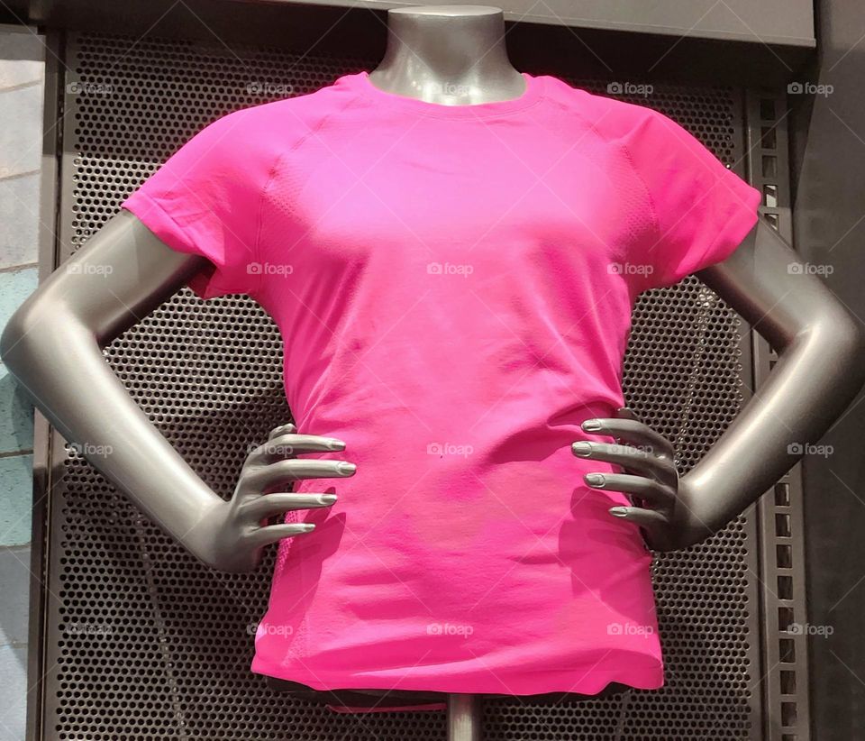 This barbie style mannequin has a "can do" attitude with hands on hips and bright pink t-shirt