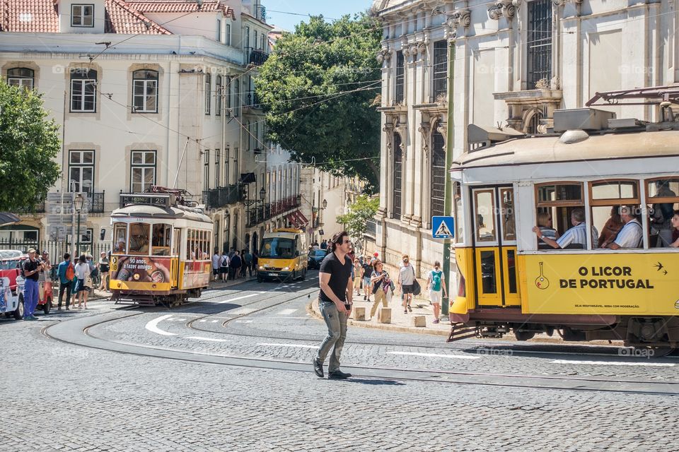 Tram 28 and people outside the cathedral Se' of Lisbon, Portugal