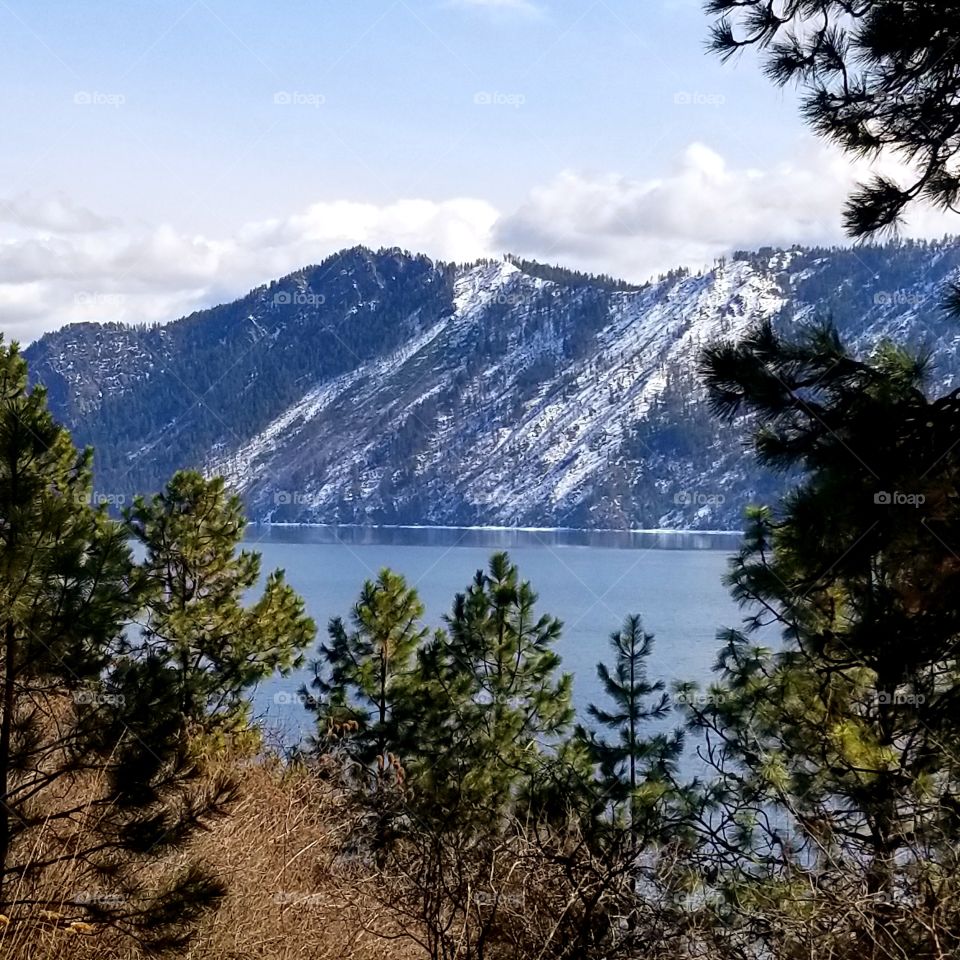 view of lake and snow covered mountain on a spring hike