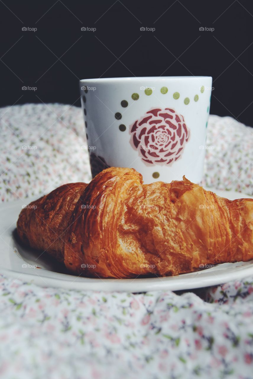 Coffee and croissant in bed