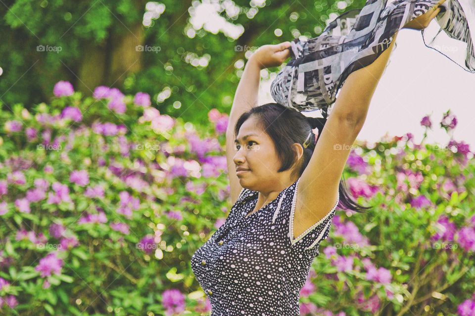 Asian woman enjoying spring. Sriwan's happy that spring is here and flower are blooming