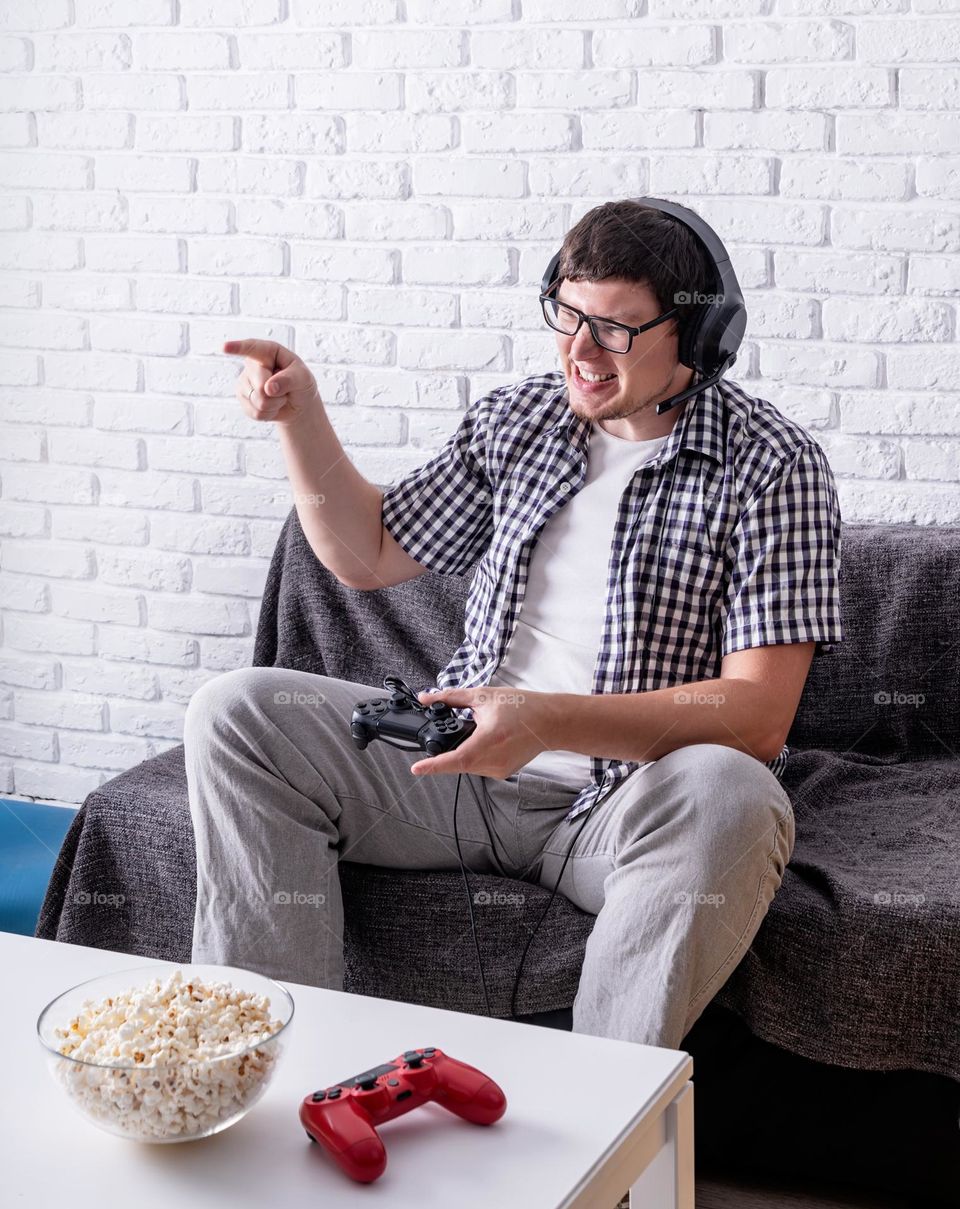 young emotional man playing video games