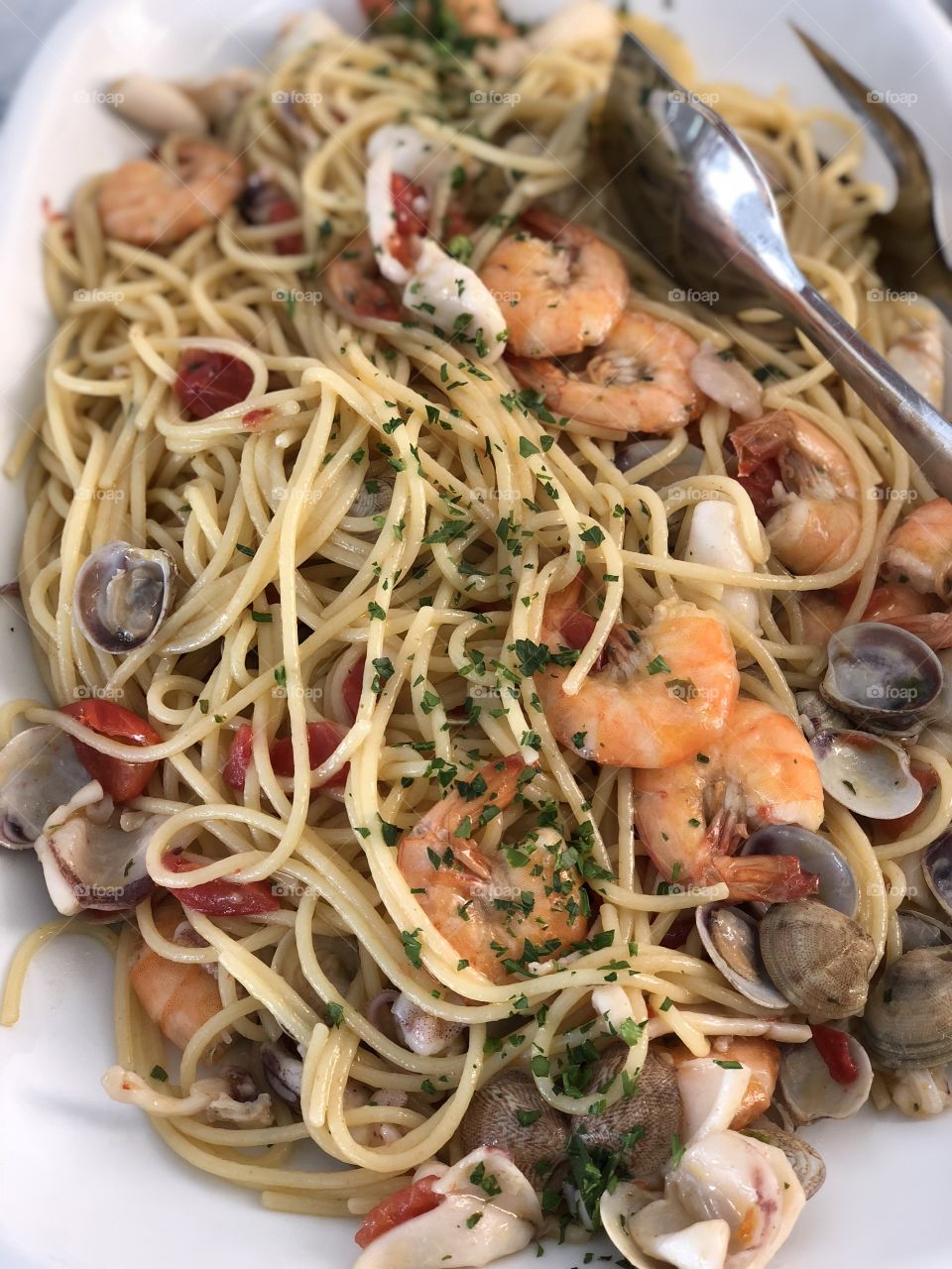 Italian shellfish pasta, closeup at the restaurant, Italy