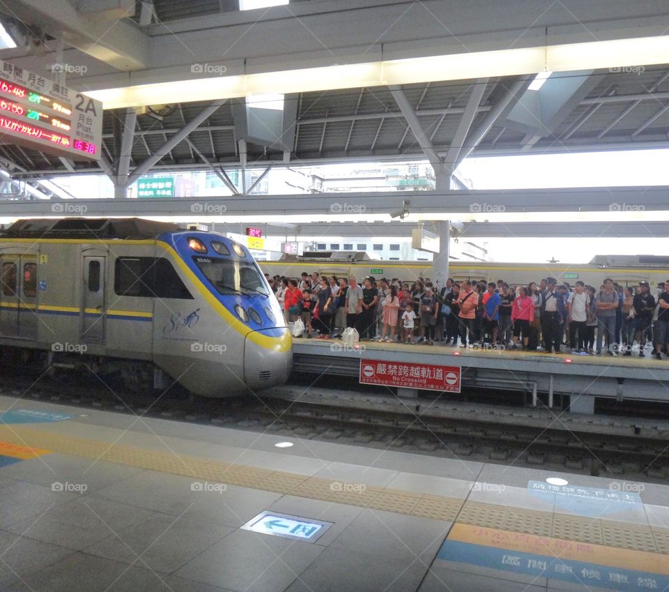 Overcrowded trains during commuting hours.The train is entering the station.