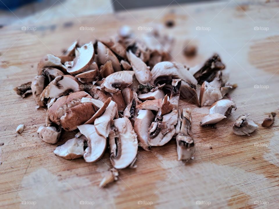 fresh chopped mushrooms on cutting board