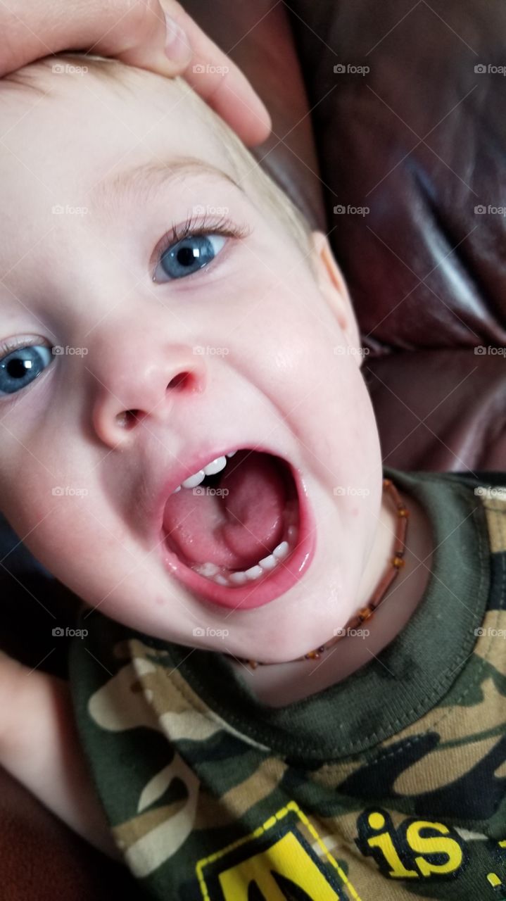 Cute little blue eyed boy with mouth open. Say ah!