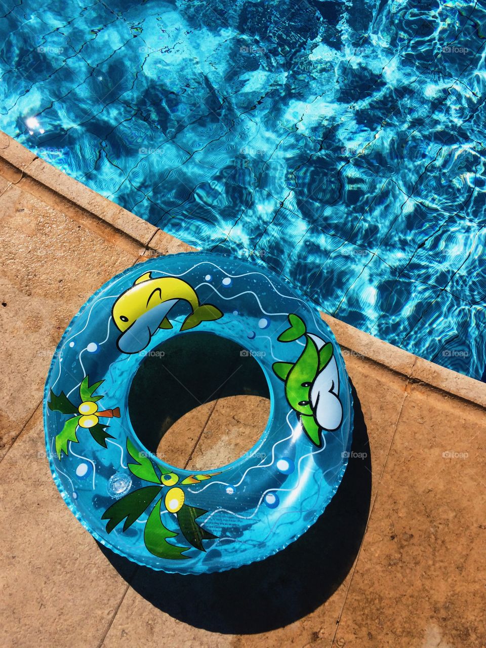 Blue inflatable ring near swimming pool